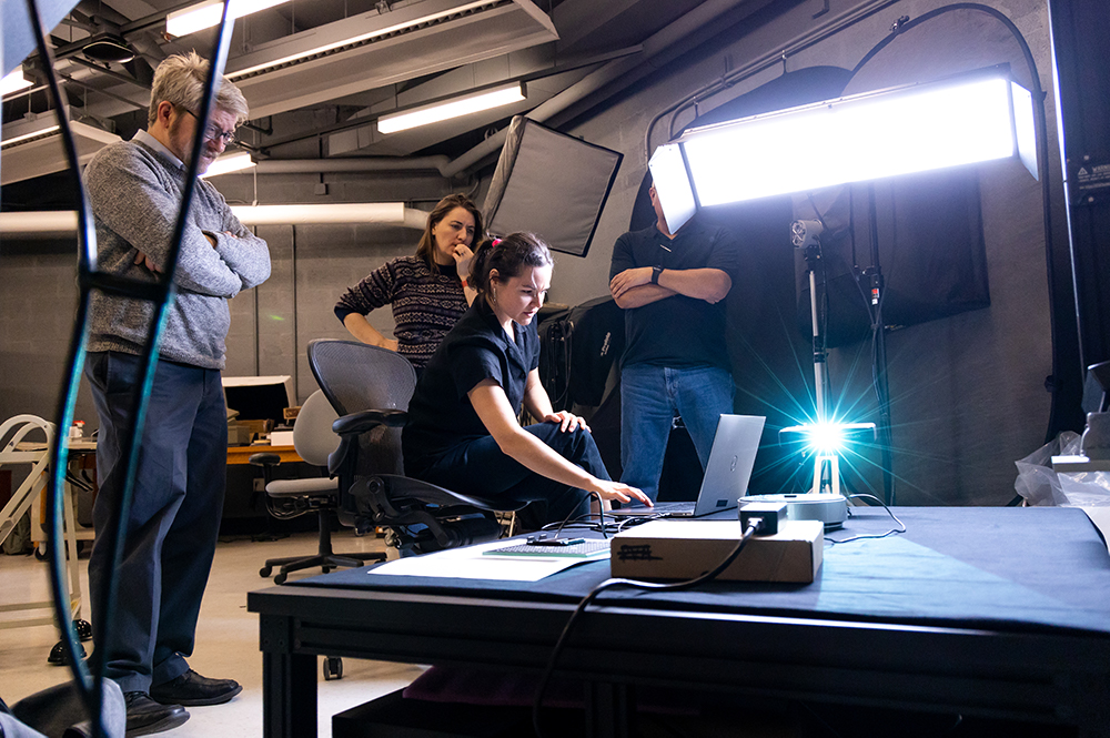 Eric White, Jen Grayburn, Roel Muñoz, and Ariel Ackerly attempt structured light scanning of a Lyons typeface piece in the Digital Imaging Studio in February 2023. Photo credit: Brandon Johnson