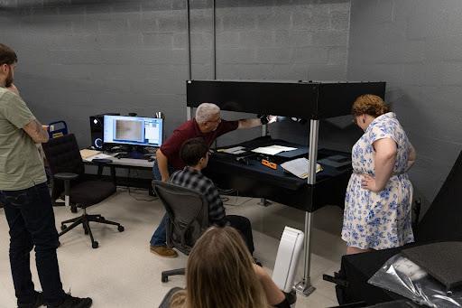 Roel Muñoz adjusts the lens of the SPSS, during a training for the Digital Scholarship team. Photo credit: Brandon Johnson