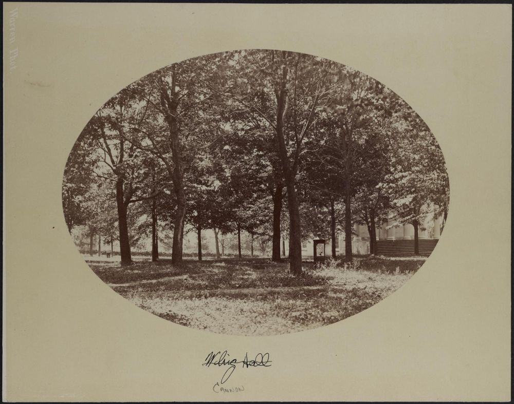 sepia colored photograph of cannon green with trees and grass surrounding the cannon in the foreground being used as a bulletin board 